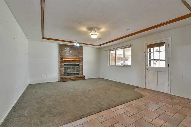 1637 NE 9th St, Moore, OK 73160 - unfurnished living room with a textured ceiling, a raised ceiling, light colored carpet, baseboards, and a brick fireplace
