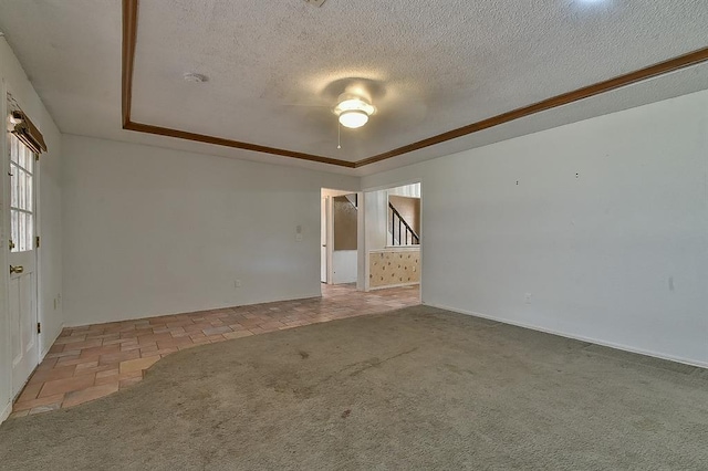 1637 NE 9th St, Moore, OK 73160 - carpeted spare room with a ceiling fan, baseboards, a textured ceiling, and a raised ceiling
