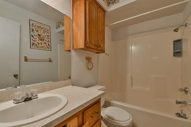 1637 NE 9th St, Moore, OK 73160 - bathroom featuring toilet, vanity, a textured ceiling, and bathing tub / shower combination