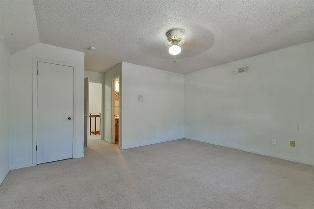 1637 NE 9th St, Moore, OK 73160 - empty room with a textured ceiling, visible vents, a ceiling fan, and light colored carpet
