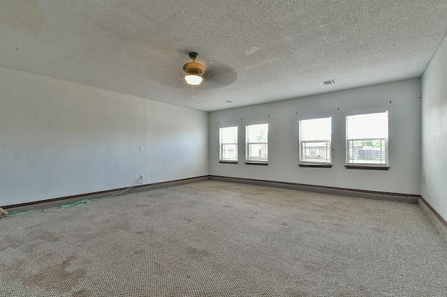 1637 NE 9th St, Moore, OK 73160 - carpeted empty room featuring a textured ceiling, visible vents, baseboards, and ceiling fan