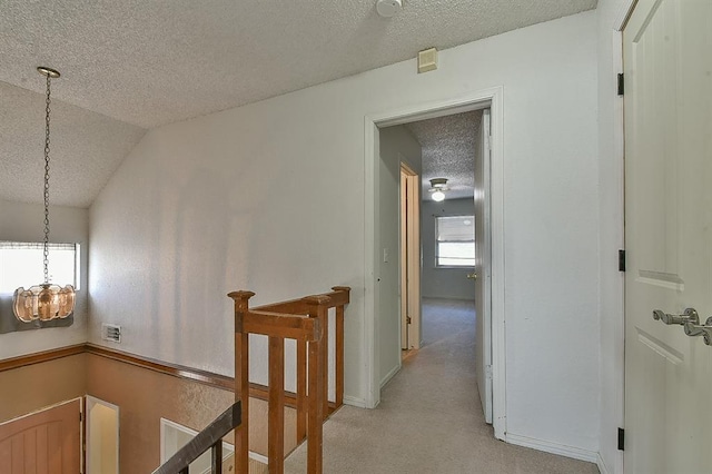 1637 NE 9th St, Moore, OK 73160 - hall with vaulted ceiling, an upstairs landing, a textured ceiling, light colored carpet, and a notable chandelier