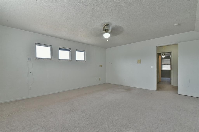 1637 NE 9th St, Moore, OK 73160 - spare room with a textured ceiling, light colored carpet, and ceiling fan