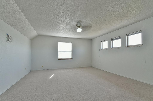 1637 NE 9th St, Moore, OK 73160 - empty room featuring light carpet, a ceiling fan, a textured ceiling, and visible vents