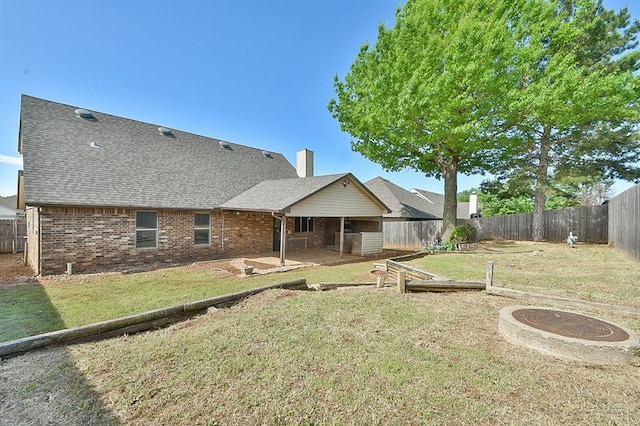 1637 NE 9th St, Moore, OK 73160 - rear view of property featuring a fenced backyard, brick siding, a yard, and a patio