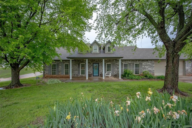 view of front of home with a front yard, a shingled roof, and stone siding