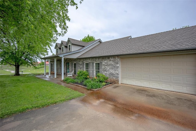 view of front of property featuring a garage, covered porch, a front yard, a shingled roof, and driveway