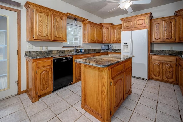 kitchen with brown cabinetry, a ceiling fan, black dishwasher, white refrigerator with ice dispenser, and a sink