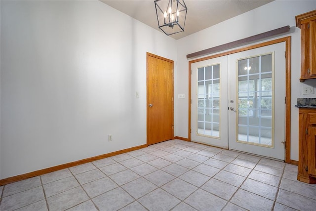 doorway to outside featuring light tile patterned floors, baseboards, french doors, and a chandelier
