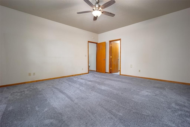 carpeted empty room featuring baseboards and ceiling fan