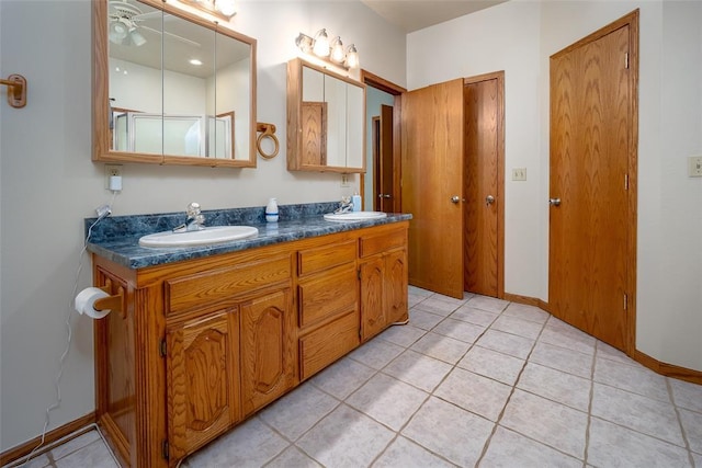 bathroom featuring double vanity, a sink, and tile patterned flooring