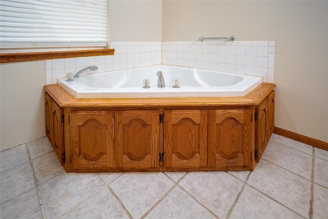full bath with a garden tub and tile patterned flooring