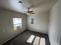unfurnished room with ceiling fan