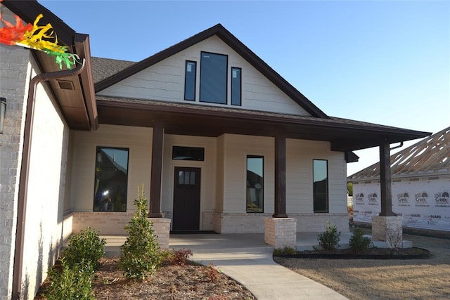1124 NW 17 Th Pl, Newcastle, OK 73065 - view of front of property featuring covered porch, brick siding, and roof with shingles
