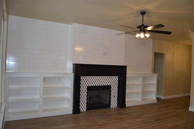 1124 NW 17 Th Pl, Newcastle, OK 73065 - room details with a tiled fireplace, baseboards, ceiling fan, and wood finished floors