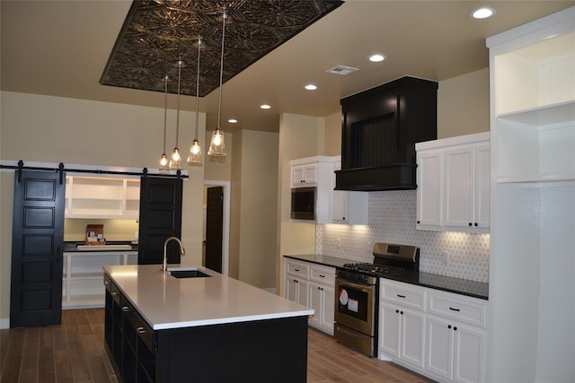 1124 NW 17 Th Pl, Newcastle, OK 73065 - kitchen with a barn door, a sink, stainless steel gas stove, wood finished floors, and backsplash