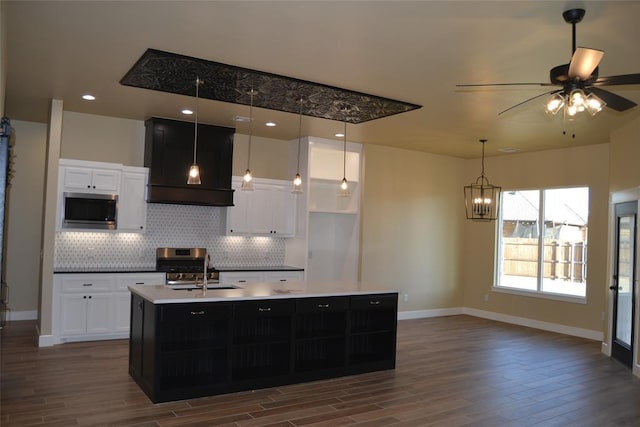 1124 NW 17 Th Pl, Newcastle, OK 73065 - kitchen with exhaust hood, backsplash, dark wood-style floors, stainless steel appliances, and white cabinetry