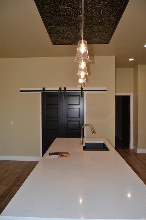 1124 NW 17 Th Pl, Newcastle, OK 73065 - kitchen with a sink, baseboards, a barn door, and dark wood-type flooring