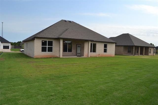 1124 NW 17 Th Pl, Newcastle, OK 73065 - rear view of house featuring a shingled roof, a yard, a patio area, and brick siding