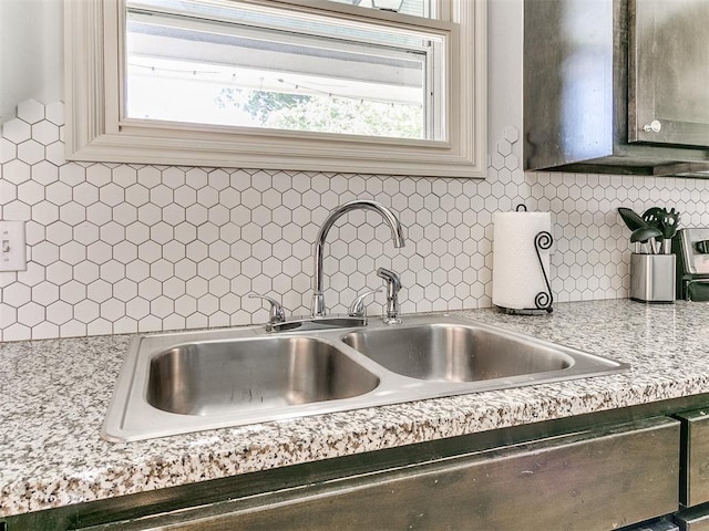 room details featuring a sink and backsplash