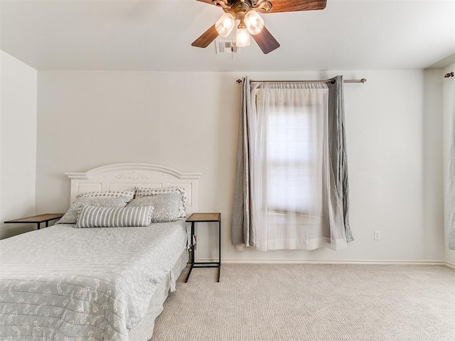 bedroom with ceiling fan, baseboards, carpet floors, and visible vents