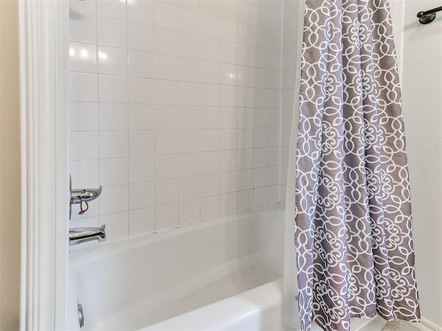 bathroom with shower / bath combo with shower curtain