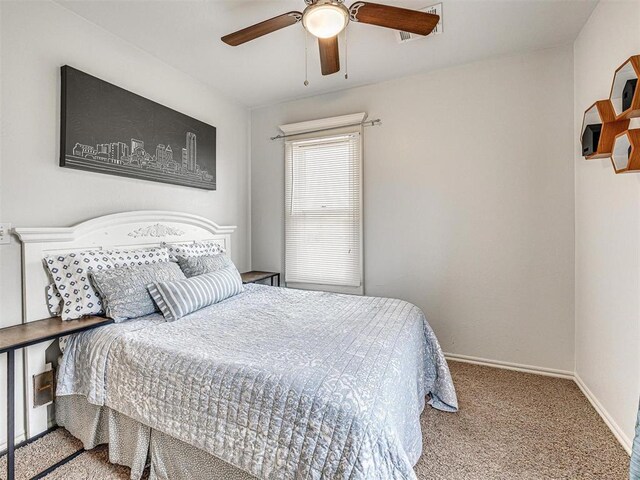 carpeted bedroom with a ceiling fan and baseboards