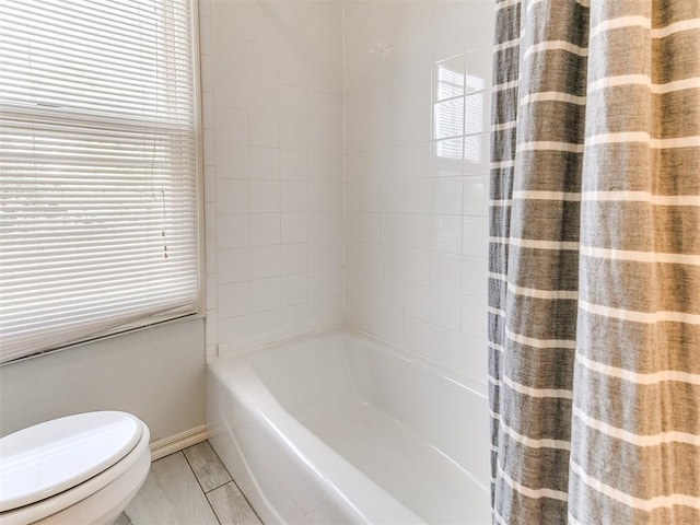bathroom with toilet and baseboards