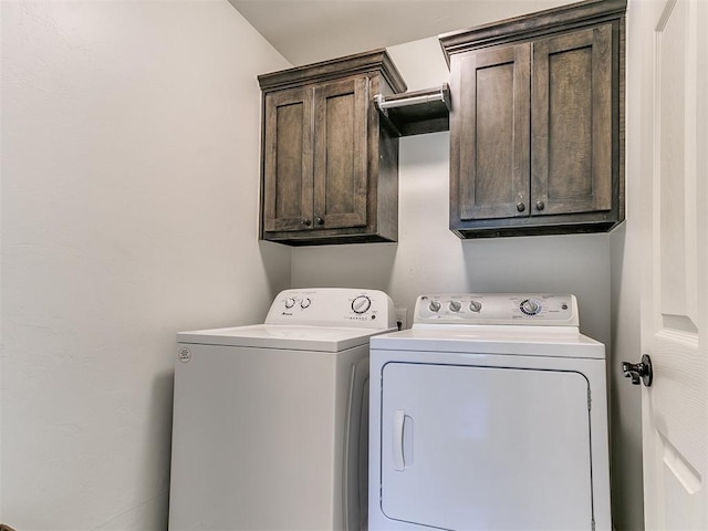 laundry area featuring washer and dryer and cabinet space