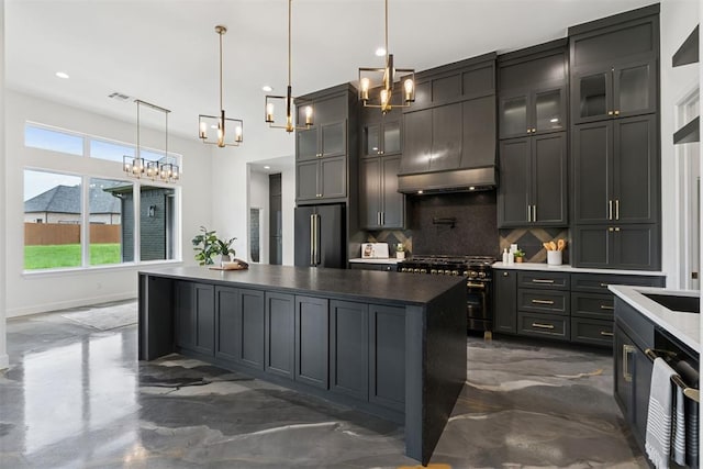 1233 Collis Ct, Newcastle, OK 73065 - kitchen with appliances with stainless steel finishes, tasteful backsplash, a chandelier, a kitchen island, and glass insert cabinets