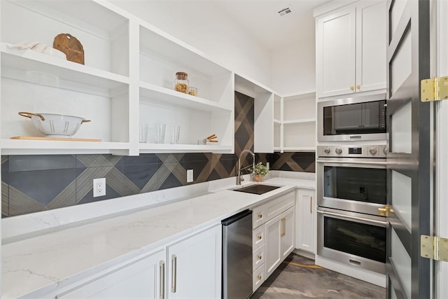 1233 Collis Ct, Newcastle, OK 73065 - kitchen with open shelves, stainless steel double oven, built in microwave, white cabinetry, and light stone countertops