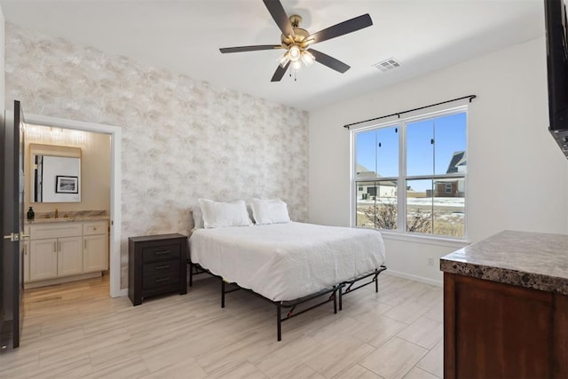 1233 Collis Ct, Newcastle, OK 73065 - bedroom featuring wallpapered walls, connected bathroom, and a ceiling fan