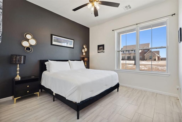 1233 Collis Ct, Newcastle, OK 73065 - bedroom featuring an accent wall, multiple windows, and a ceiling fan