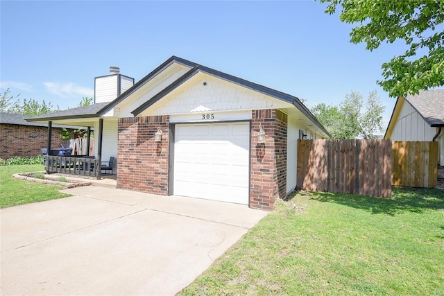exterior space with fence, a chimney, a front yard, and brick siding