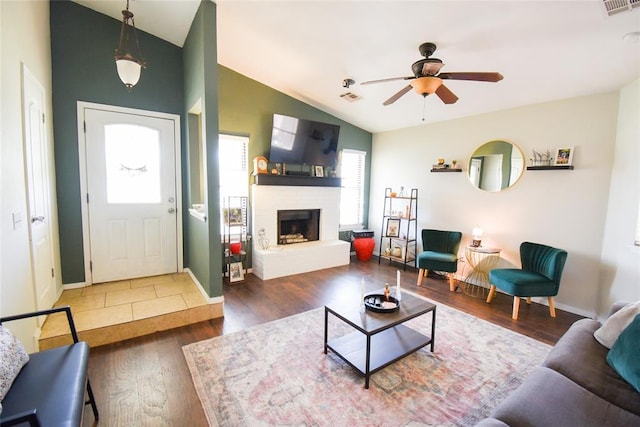 living room with wood finished floors, a healthy amount of sunlight, a ceiling fan, and vaulted ceiling