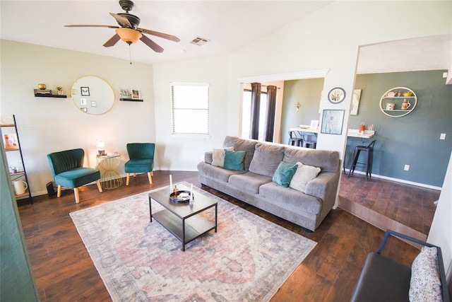 living room with baseboards, visible vents, wood finished floors, and a ceiling fan