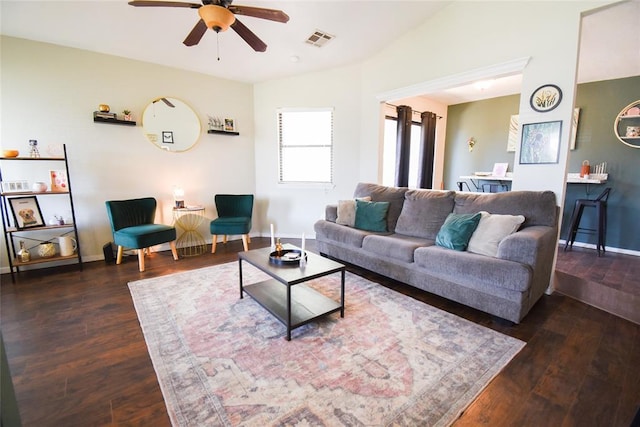 living room featuring a ceiling fan, visible vents, lofted ceiling, and wood finished floors