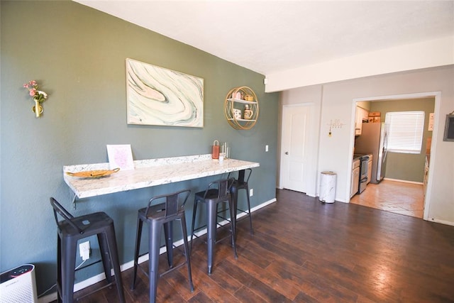 dining area featuring wood finished floors and baseboards