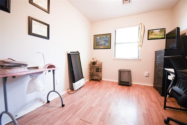 office space featuring visible vents, baseboards, and light wood-style floors