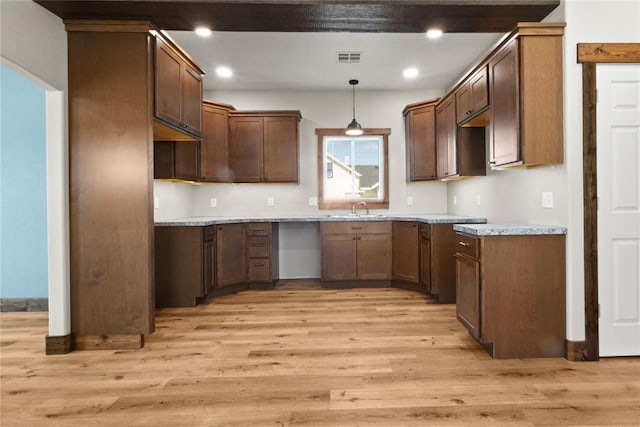 kitchen with visible vents, a sink, light wood finished floors, and recessed lighting