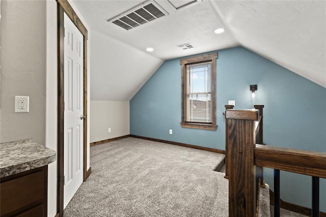 bonus room with baseboards, vaulted ceiling, visible vents, and carpet