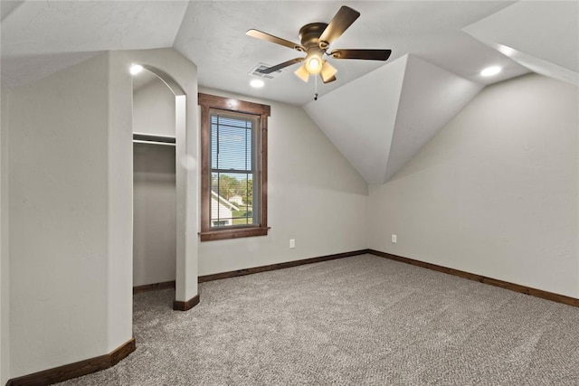 additional living space with baseboards, vaulted ceiling, carpet flooring, and ceiling fan