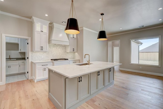 6508 NW 146th St, Oklahoma City, OK 73142 - kitchen featuring white cabinets, custom exhaust hood, a sink, and backsplash