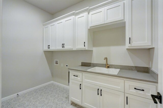 6508 NW 146th St, Oklahoma City, OK 73142 - laundry room with a sink, electric dryer hookup, cabinet space, baseboards, and washer hookup