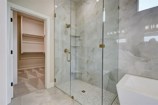 6508 NW 146th St, Oklahoma City, OK 73142 - bathroom featuring a shower stall, baseboards, a walk in closet, and a bathing tub