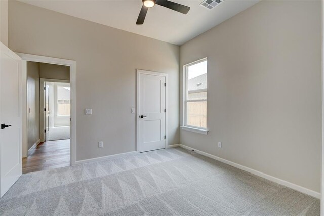6508 NW 146th St, Oklahoma City, OK 73142 - empty room with light carpet, baseboards, visible vents, and ceiling fan