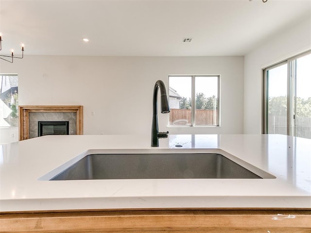 kitchen with visible vents, a sink, a wealth of natural light, and light countertops