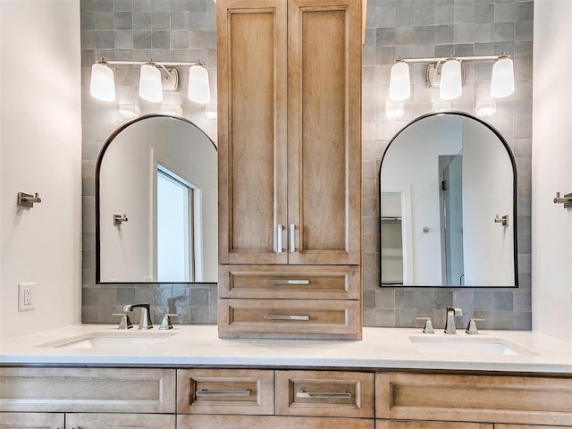 full bathroom featuring backsplash, double vanity, and a sink