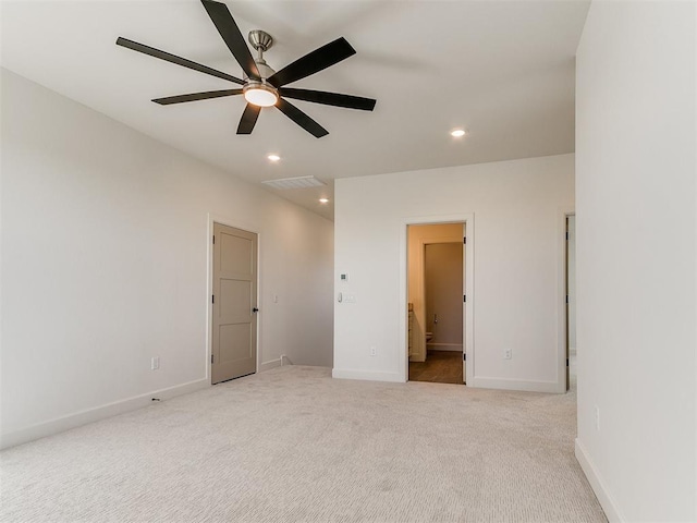 unfurnished bedroom with recessed lighting, carpet flooring, baseboards, and ensuite bath