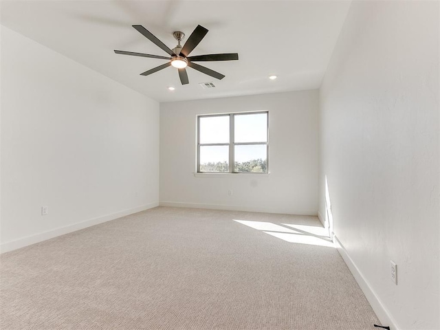 unfurnished room with visible vents, baseboards, recessed lighting, light carpet, and a ceiling fan